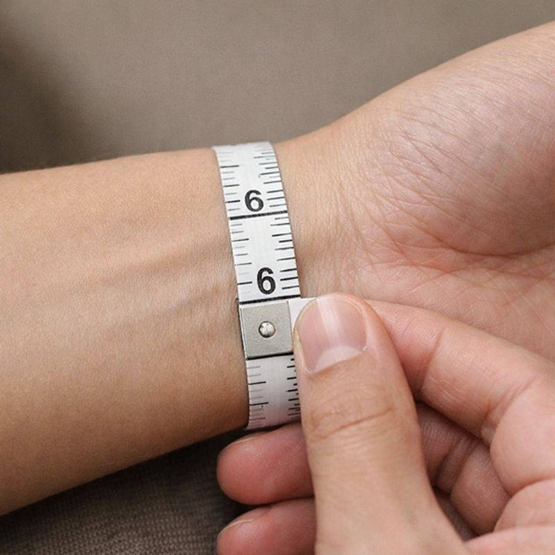 Close-up of a person measuring wrist size with a flexible tape for a comfortable and snug watch band fit
